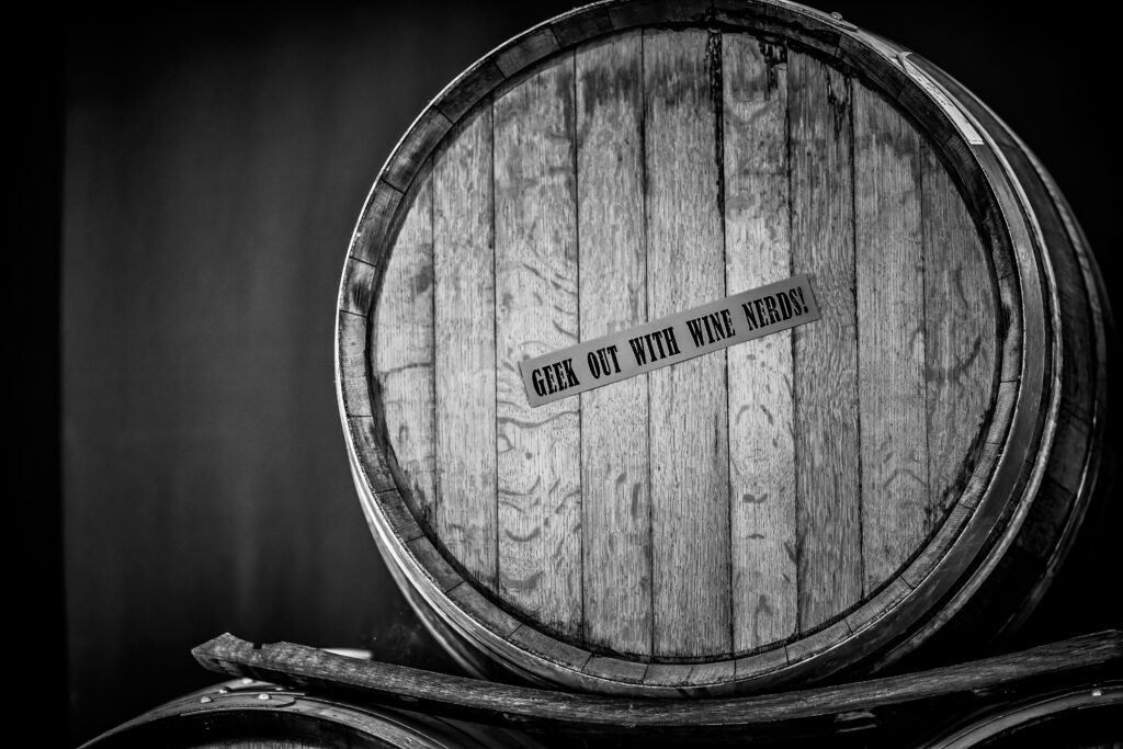 Image of the head of a barrel with the sticker 'Geek Out With Wine Nerds!' on it.